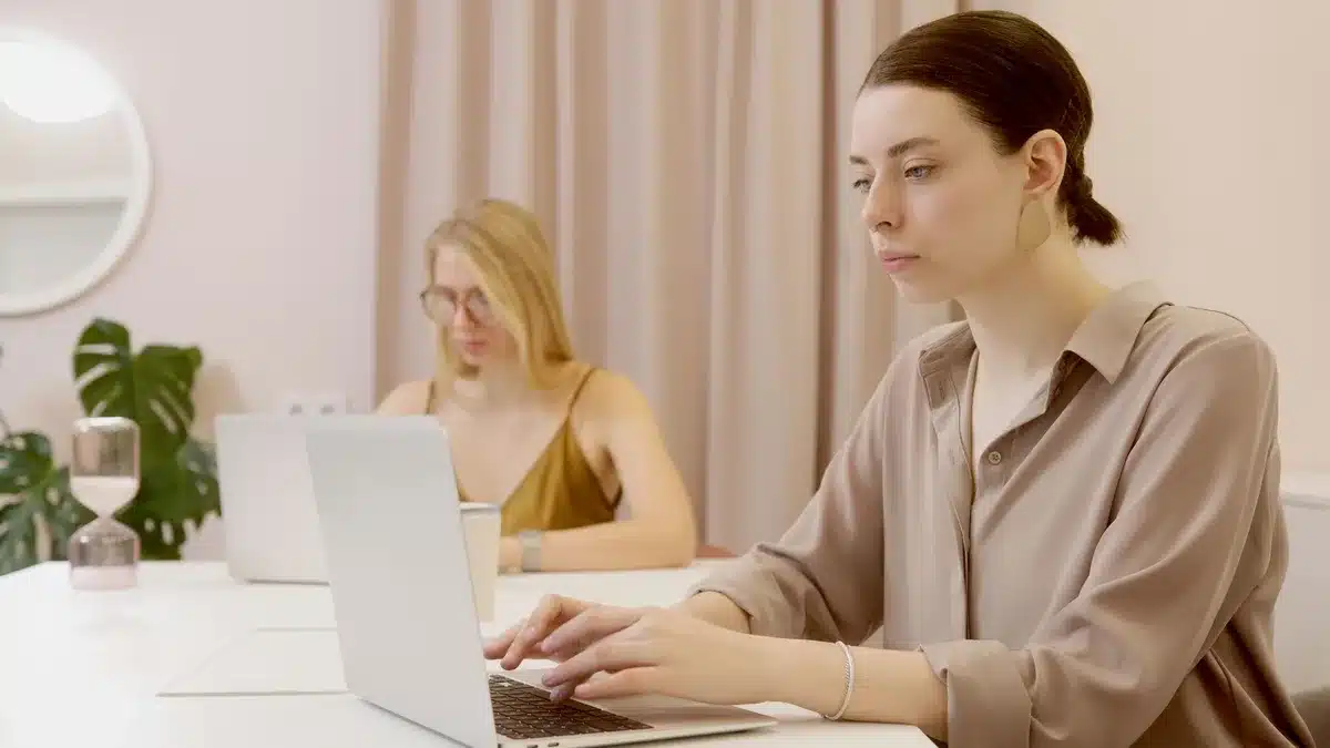 Office workers at desks with computers, focused on tasks amid documents and time pressure