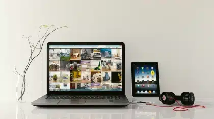 Hands interacting with AI-powered devices and smartphone interface in a modern workspace